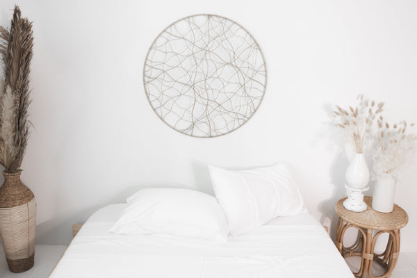picture of the one sheet in the white color on a bed in a bedroom