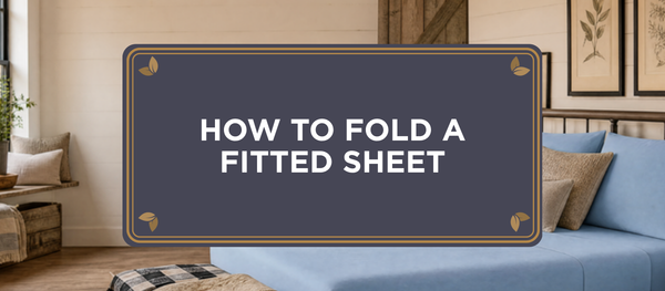 How to fold a fitted sheet, blog header showing a made bed dressed in Light Blue organic bamboo viscose connected sheets in a modern farmhouse bedroom