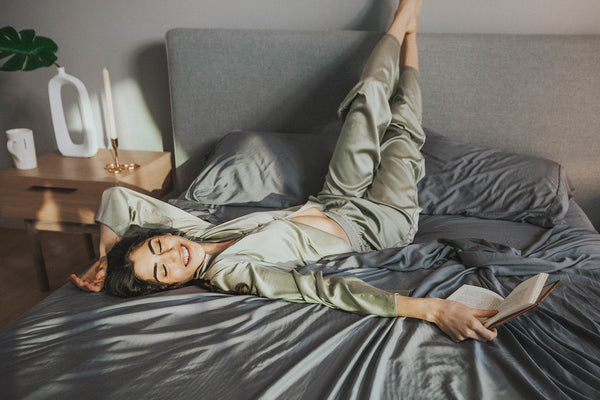 Girl waking in bed peacefully enjoying the one sheet by sova